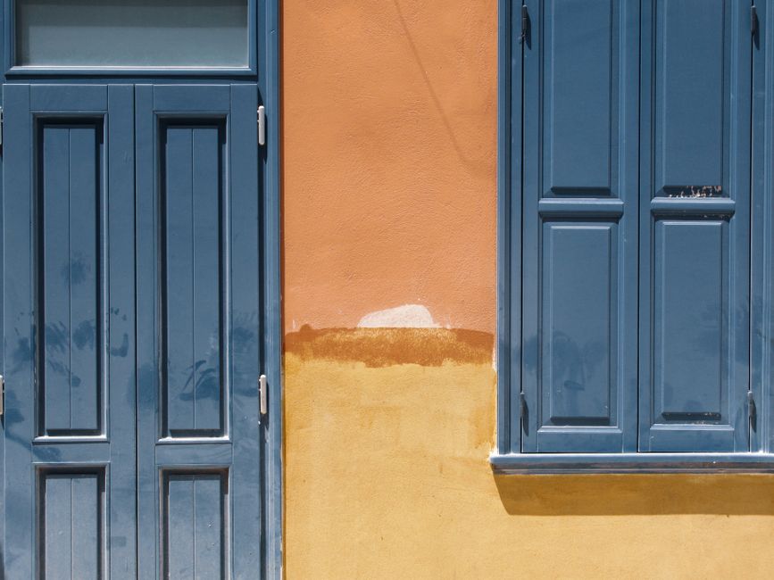 A house wall with fresh paint and a window