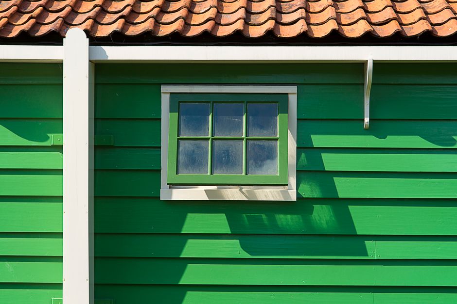 A painted house exterior with trim and a door