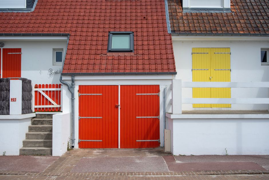 A painted house exterior with trim and a door